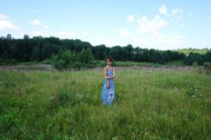In blue dress in field